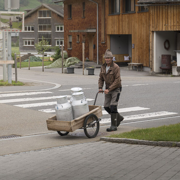 Die Milch wird jeden Tag frisch vom Bauern geliefert (Foto: Michael Kreyer) Ein Bauer führt drei Kannen Milch in einer Handkarre zur Bergkäserei Schoppernau für die weitere Verarbeitung.